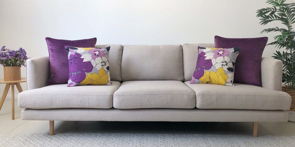 Grey Sofa With Purple And Yellow Floral Cushions