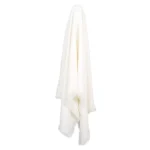 A soft white linen throw hanging from a hook.