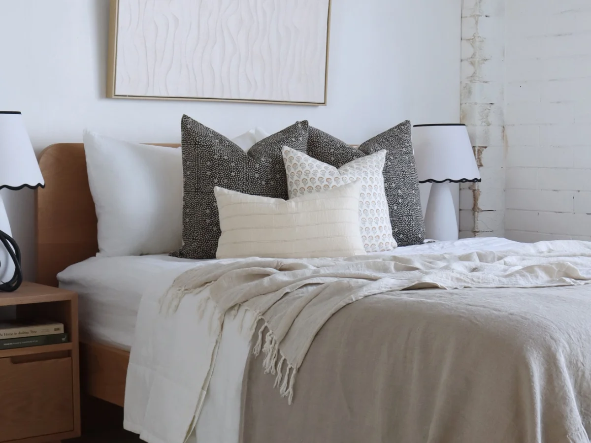 A bed decorated with cushions.