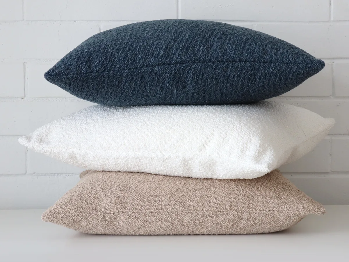 Stacked cushions with boucle fabric that has excellent texture.