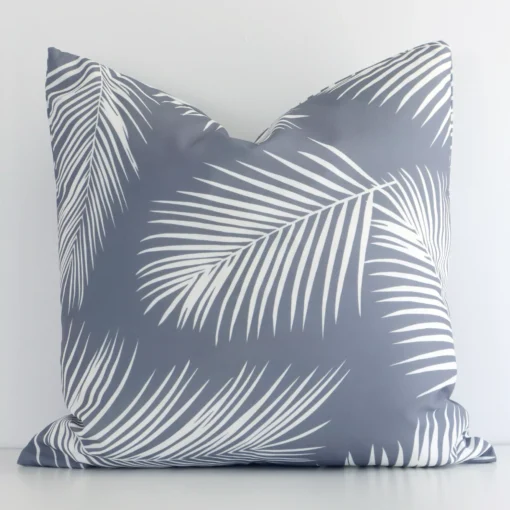 An attractive outdoor cushion in front of a white wall. It has a square shape and is grey in colour.