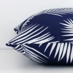 Lateral viewpoint of this outdoor square cushion. The palm design and navy colour are shown from the side showing the front and rear panels.