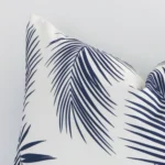 A detailed shot of this navy palm styled cushion cover that has outdoor fabric and a rectangle size.