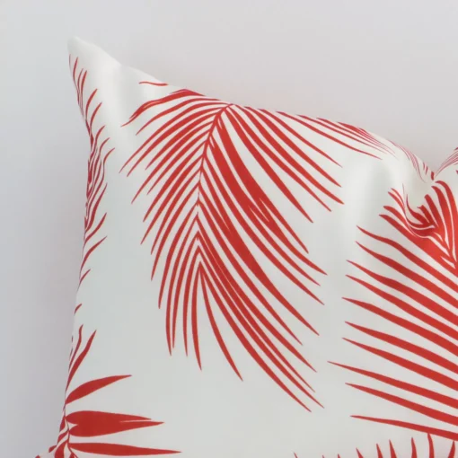 A graceful rectangular cushion with a red palm style on durable outdoor fabric.