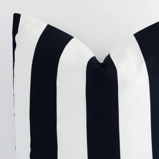 This image shows a black and white striped cushion cover from a very close range. The large size and outdoor material are more clearly shown.