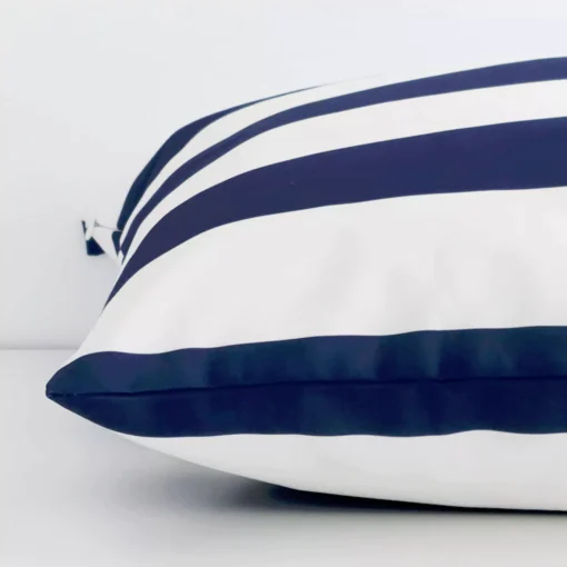 Horizontal edge view of front and back panels of a striped outdoor cushion in a large size and with navy colouring.