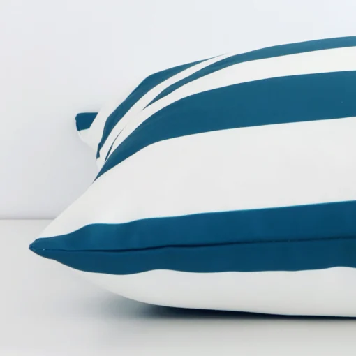 A large outdoor cushion positioned flat to show its seams. The teal colour and striped design are visible as is the seam between the panels.