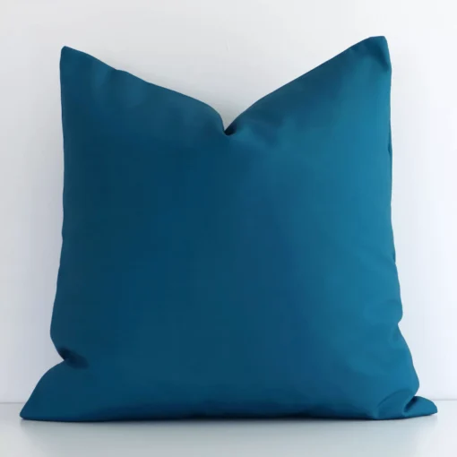 Gorgeous square outdoor cushion cover that has a teal hue. It has a graceful solid-coloured design.