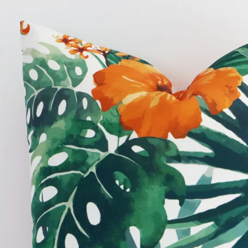 Close up image of outdoor square cushion. The image allows you to see the orange hue and floral style more thoroughly.