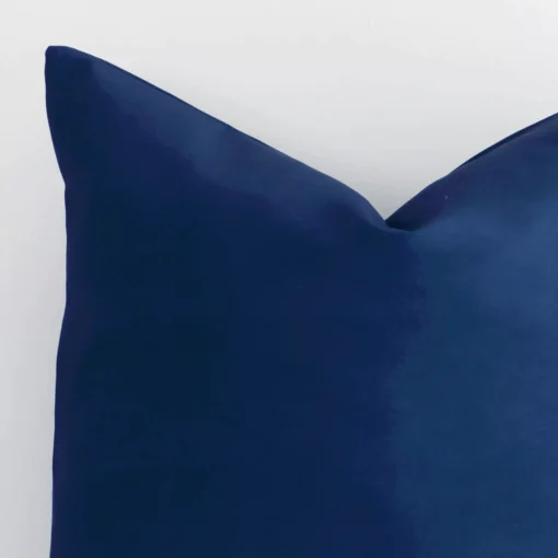 Magnified view of this outdoor blue cushion cover’s corner showing a solid-coloured design and its square size.