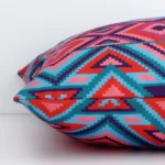 Outdoor cushion laying on its side. The geometric design and its square shape are visible.