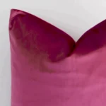 Close up image of top corner of this solid-colured blush cushion. This shows the velvet fabric and square shape up close.