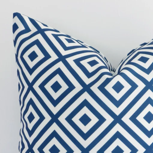 Close up image of top corner of this geometric blue cushion. This shows the outdoor fabric and square shape up close.