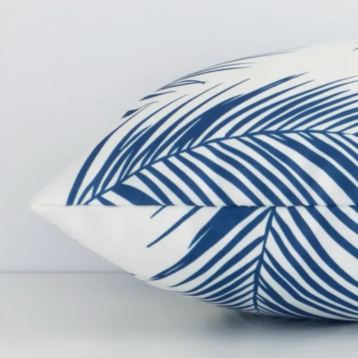 The seams of this outdoor rectangle cushion cover in blue are shown. The image shows the palm design and how the panels are attached.