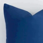 Macro image of a outdoor square cushion cover. The shot shows the blue hue and bold style more thoroughly.