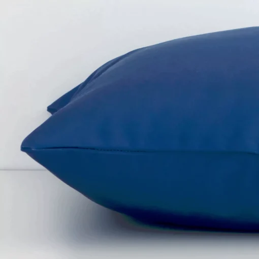 Side angle of bold blue cushion cover that has outdoor fabric and a square size.