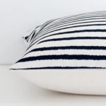 A sideways perspective of this stripe outdoor cushion. The positioning shows the border of the large size.