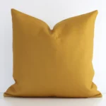 An eye-catching linen square cushion cover featuring a hue that is mustard. It has a solid-coloured style.