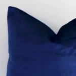 Close up image of velvet square cushion. The image allows you to see the royal blue hue and solid colour style more thoroughly.