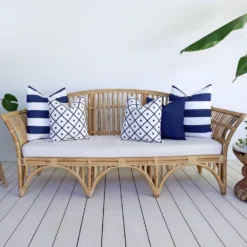 5 outdoor sofa cushions in navy colour shown on a rattan seat.